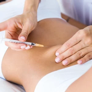 Close-up of a cosmetic practitioner administering an injection into a woman's abdomen during a non-surgical body contouring or fat reduction treatment.