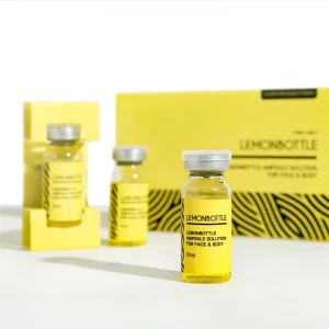A product display of "LEMONBOTTLE" ampoule solution for face and body. The image shows three small yellow vials with silver caps, placed in front of a larger matching yellow product box. The label reads "LEMONBOTTLE Ampoule Solution for Face & Body, 10ml" with a bold black and yellow design.