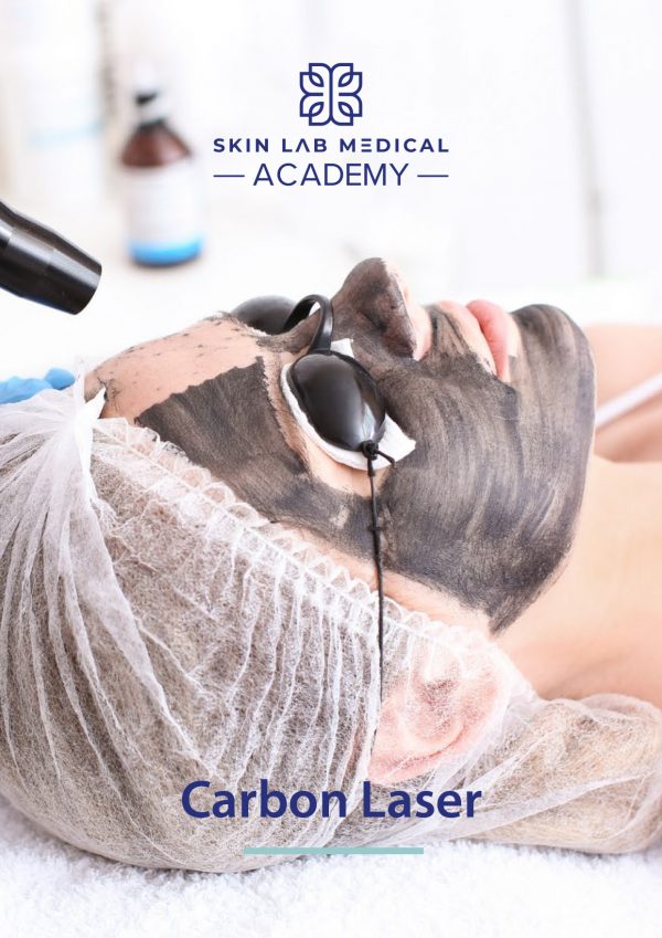 A person lies down with a black carbon mask applied to their face while wearing protective goggles. A handheld laser device is being used on the skin as part of a carbon laser facial treatment. The individual wears a disposable hair cover.