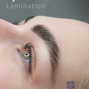 Close-up side view of a woman's face focusing on her neatly groomed and lifted eyebrow, promoting an eyebrow lamination treatment.