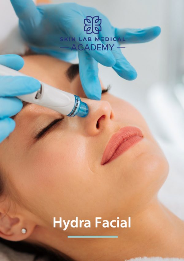 Close-up of a woman receiving a HydraFacial treatment at a clinic, with a gloved practitioner using a specialized device on her nose. The woman is relaxed with eyes closed, showcasing a skincare procedure under the branding of Skin Lab Medical Academy.