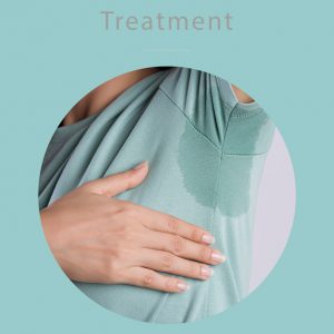 Close-up of a person wearing a light green shirt with a visible underarm sweat stain, gently holding their armpit, illustrating hyperhidrosis treatment awareness on a teal background.