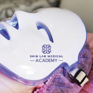 Client undergoing L.E.D. light therapy wearing a full-face mask during treatment at Skin Lab Medical Academy.